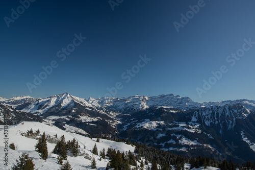 Beautiful mountain panorama from Leysin range on a cloudy winter day. Looking towards Les Diablerets ski centre and valley below.