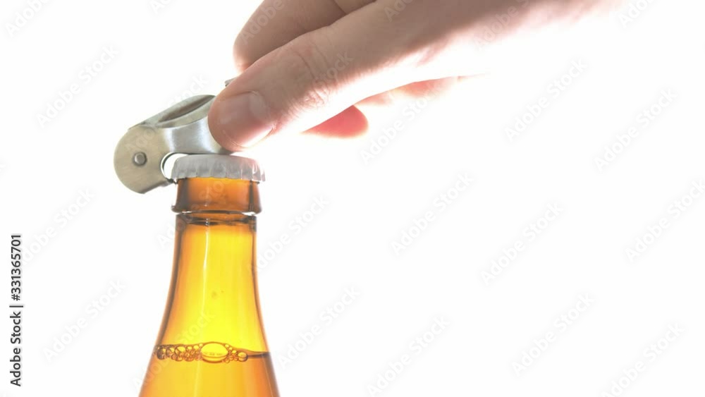 Opening a bottle of cold beer. Close up slow motion shot isolated on the white background Opening a bottle of cold beer. Close up slow motion shot isolated on the white background