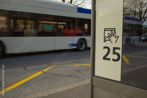 Bus station or bus stand with number 25 visible in Lausanne, Switzerland. One of the buses just driving past the station.
