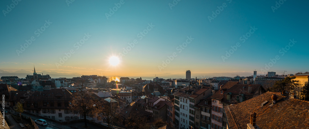 Obraz premium Panorama from Cathedral of Lausanne on the top of the hill in early evening hours. Panoramic evening view of Lausanne city from the Cathedral hill.