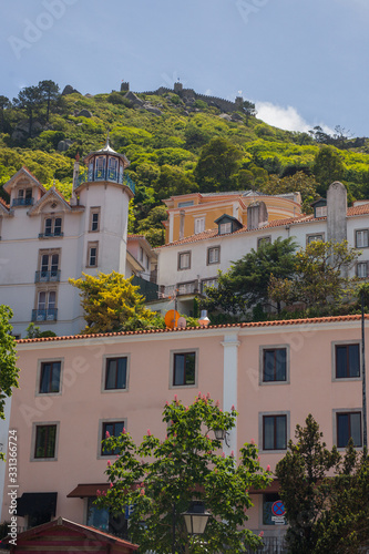 Houses in the village of Sintra, Portugal, on a warm summer day. Looking up from the tow towards the castle. © Anze