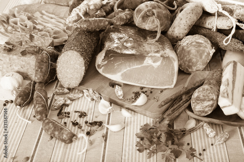 Variety of meats and sausages  on table photo