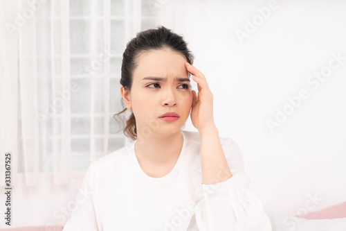 Young woman feel sick and unwell on bed