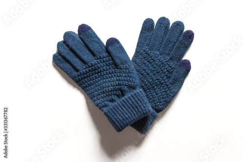 Dark blue knitted touch screen gloves isolated on white background. 