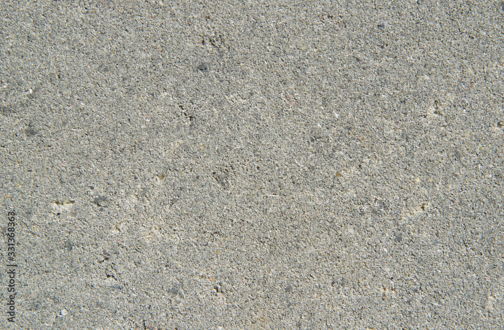 Light gray sand texture. Background with small interspersed grains of sand grains close-up. Rough concrete surface Light gray sand texture. Background with small interspersed grains of sand grains close-up. Rough concrete surface