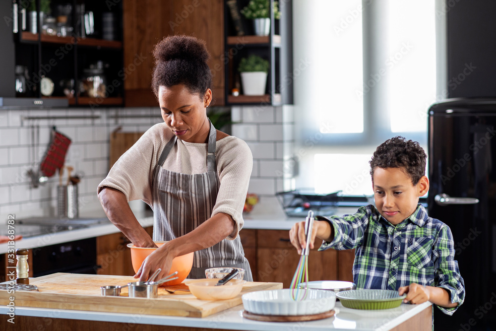Mother with his son prepare pie in the kitchen Mother with his son prepare pie in the kitchen