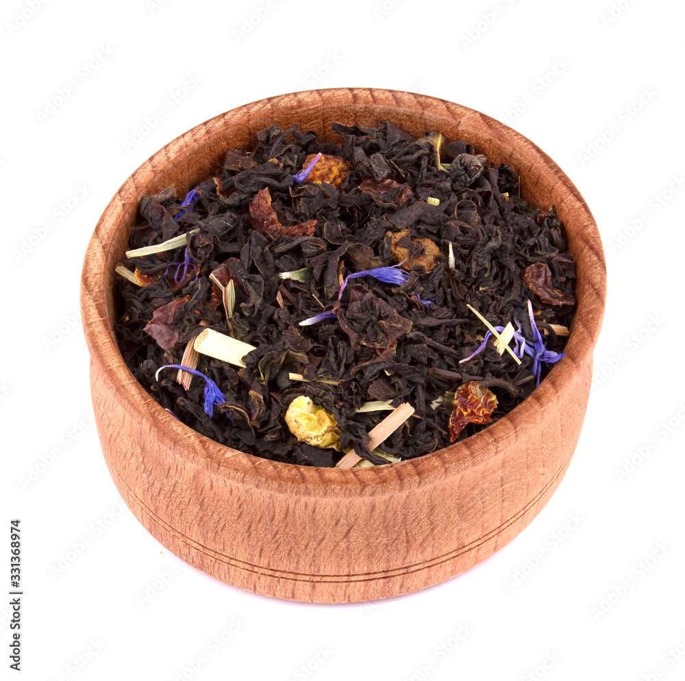 Dried black tea with slices of dried cherry, safflower petals in a wooden bowl, delicious, natural Dried black tea with slices of dried cherry, safflower petals in a wooden bowl, delicious, natural