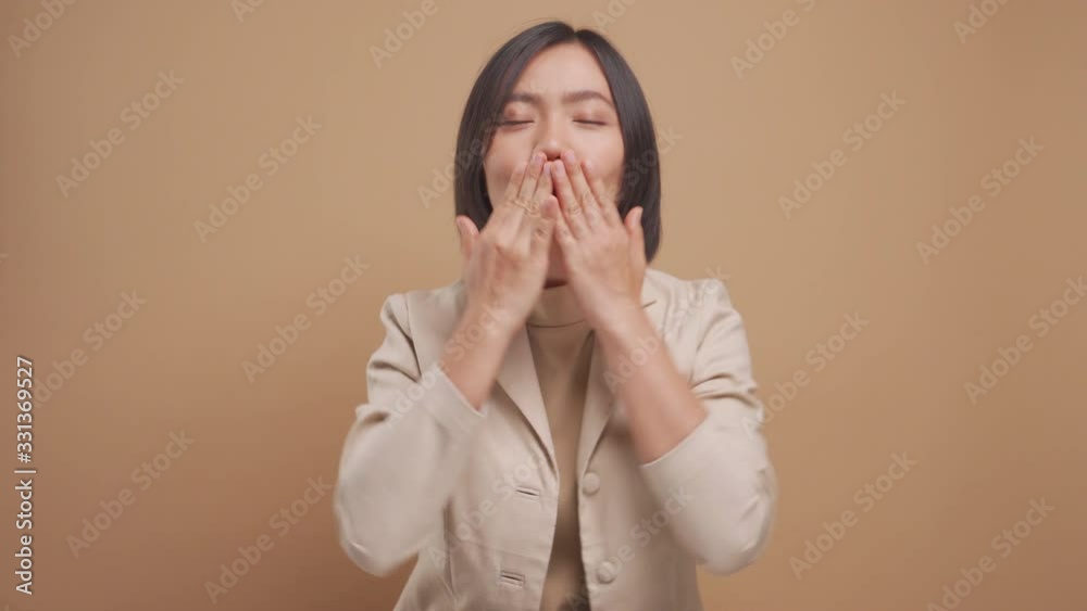 Happy asian business woman in love sending air kiss and looking at camera isolated over beige background. 4K video Happy asian business woman in love sending air kiss and looking at camera isolated over beige background. 4K video