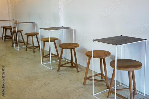 Interior design and decoration of coffee cafe and dining restaurant -decorated with wooden chair and minimal furniture in white wall room