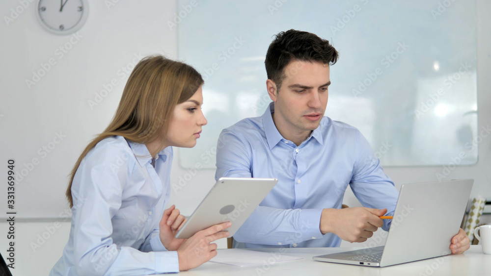 Two Young Business Colleagues Working on Laptop Two Young Business Colleagues Working on Laptop