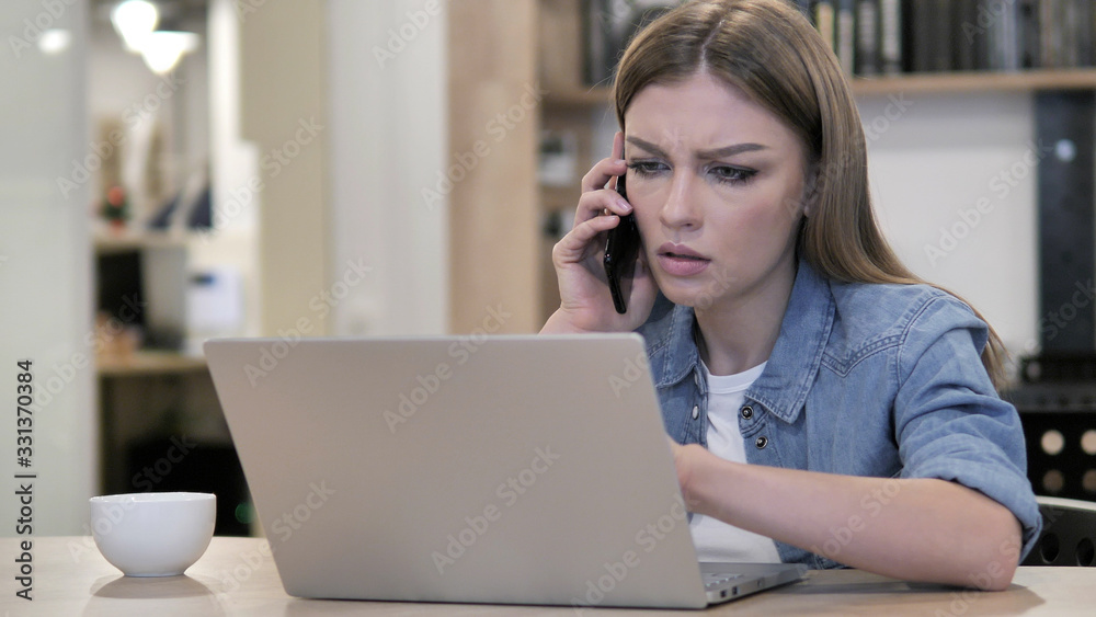 Young Girl Talking on Phone and Discussing Progress Young Girl Talking on Phone and Discussing Progress