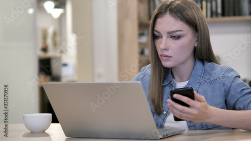 Creative Woman Working with Smartphone and Laptop