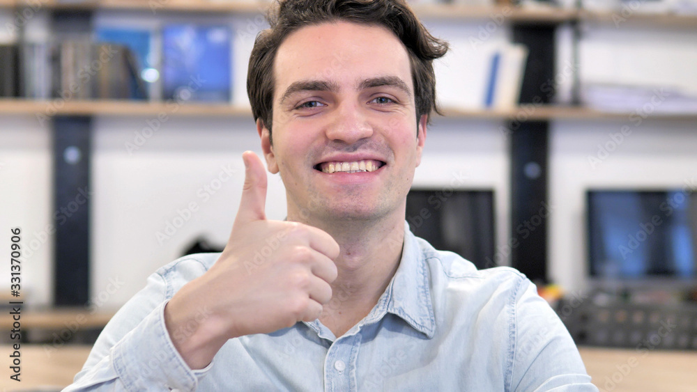 Thumbs Up by Creative Man Looking at Camera at Work Thumbs Up by Creative Man Looking at Camera at Work