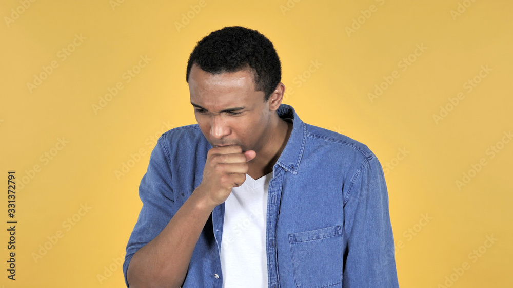 Sick Young African Man Coughing Isolated on Yellow Background Sick Young African Man Coughing Isolated on Yellow Background