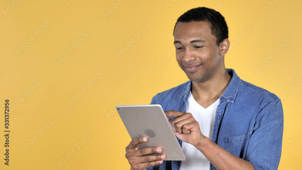 Young African Man Browsing Internet, Using Tablet Young African Man Browsing Internet, Using Tablet