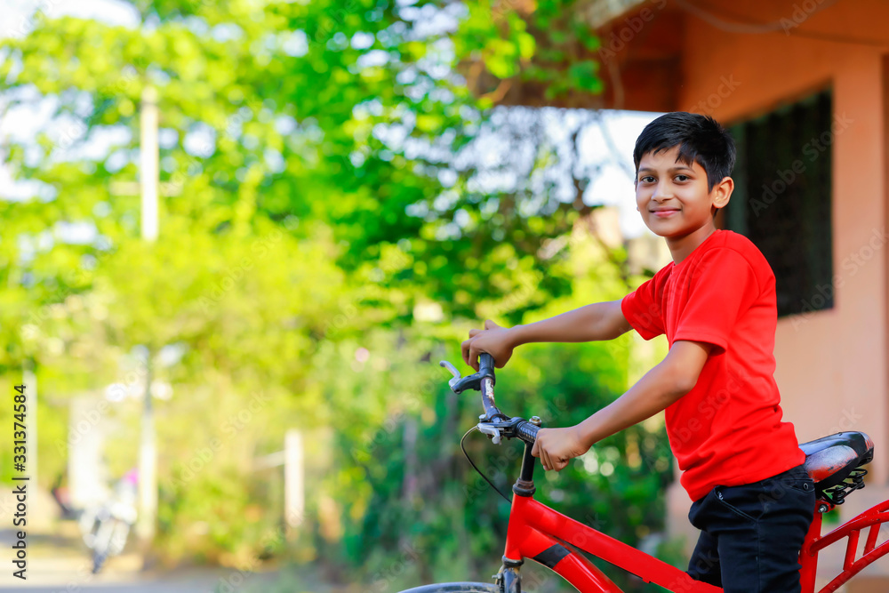 indian little boy enjoy cycle riding