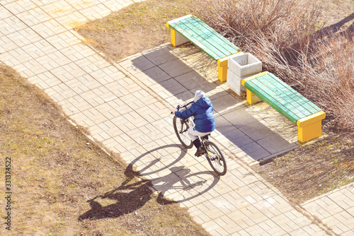 Wallpaper Mural The boy rides a bike in the yard on a sunny day in early spring Torontodigital.ca