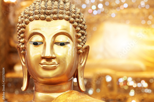 Photography Golden buddha face on golden background at Thai temple.