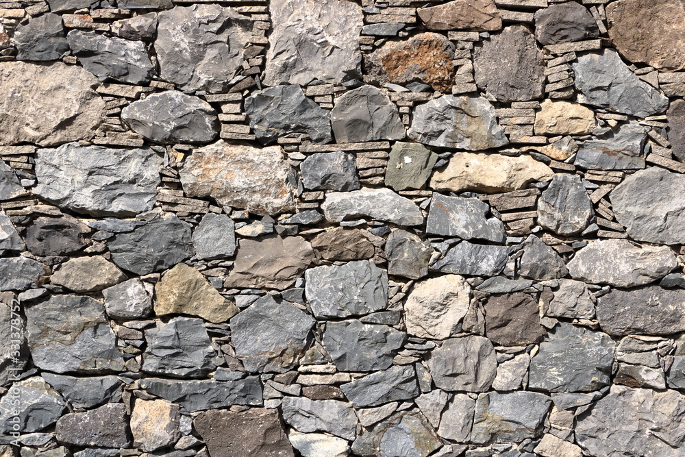 Texture of a grey granite stone wall for background Texture of a grey granite stone wall for background