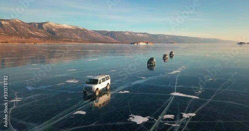 Extreme driving on the on frozen lake. Off-road vehicles in the winter. Baikal, Russia
