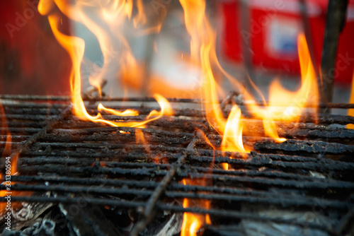 Steel grate for grilling food on charcoal that is combustible and hot.
