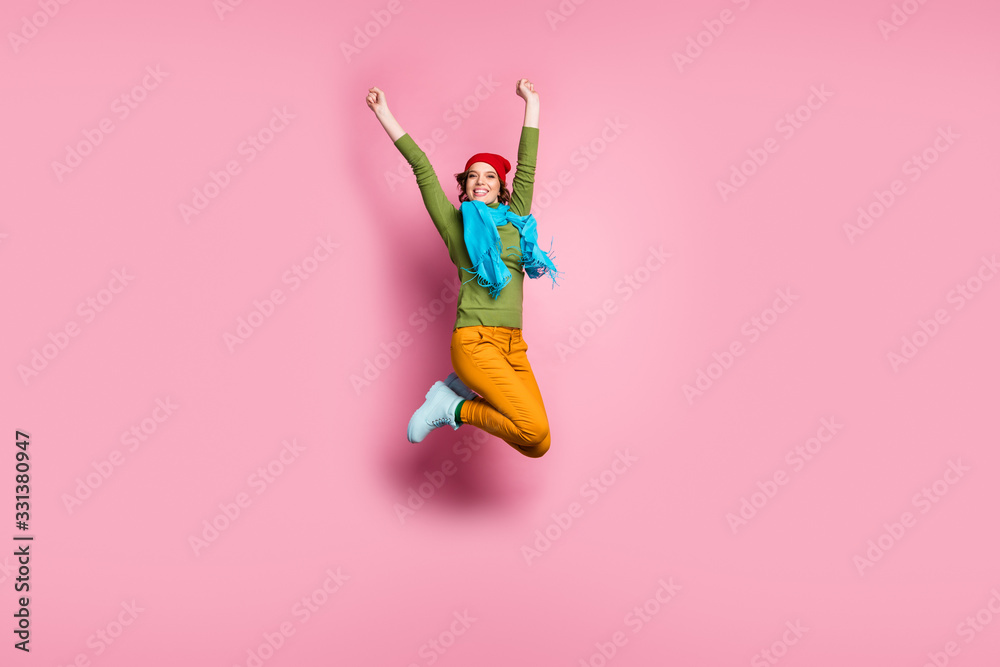 Full size photo of lovely sweet girl enjoy lottery victory success jump raise fists wear autumn style footwear outfit trousers sweater isolated over pink color background