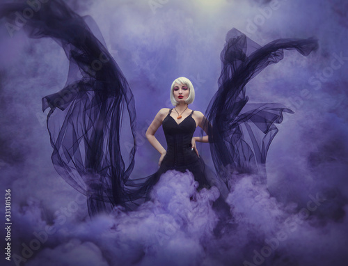 Fotografie Wicked mermaid witch in a black dress underwater