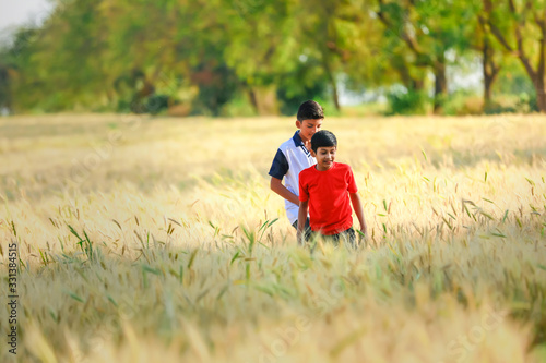 Indian / Asian little boy playing in wheat field © PRASANNAPIX