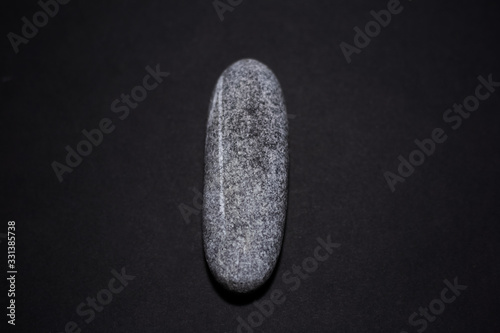 Close-up of stone isolated on black background.