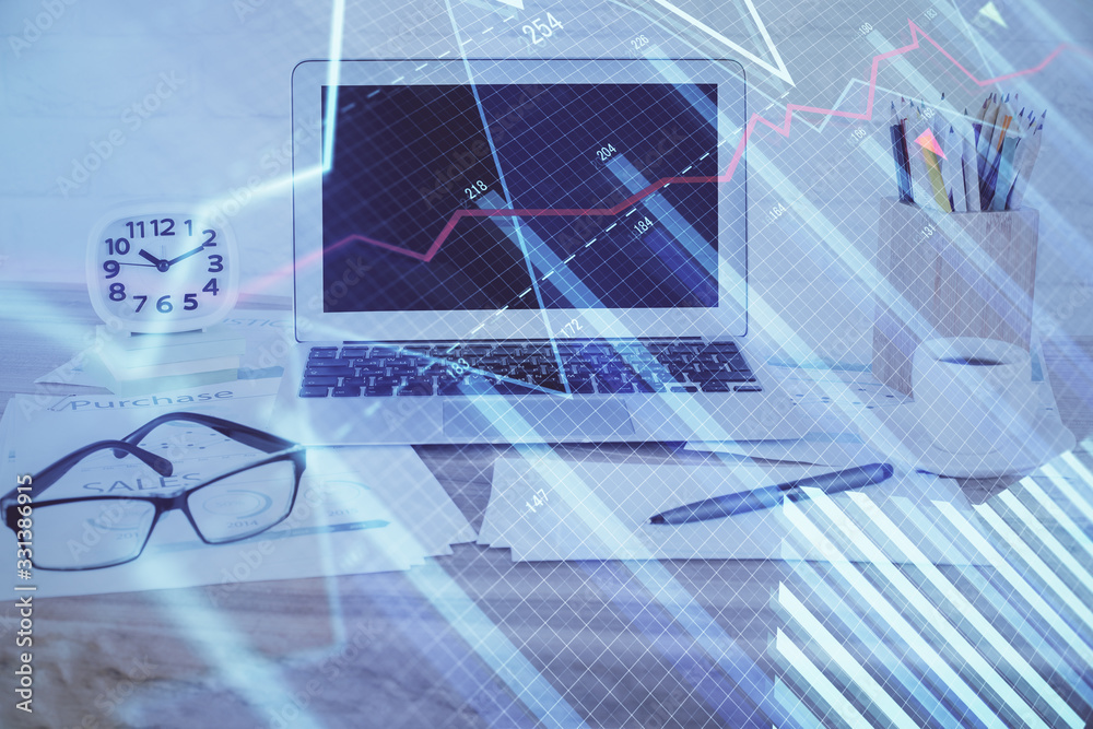 Forex market graph hologram and personal computer on background. Multi exposure. Concept of investment. Forex market graph hologram and personal computer on background. Multi exposure. Concept of investment.
