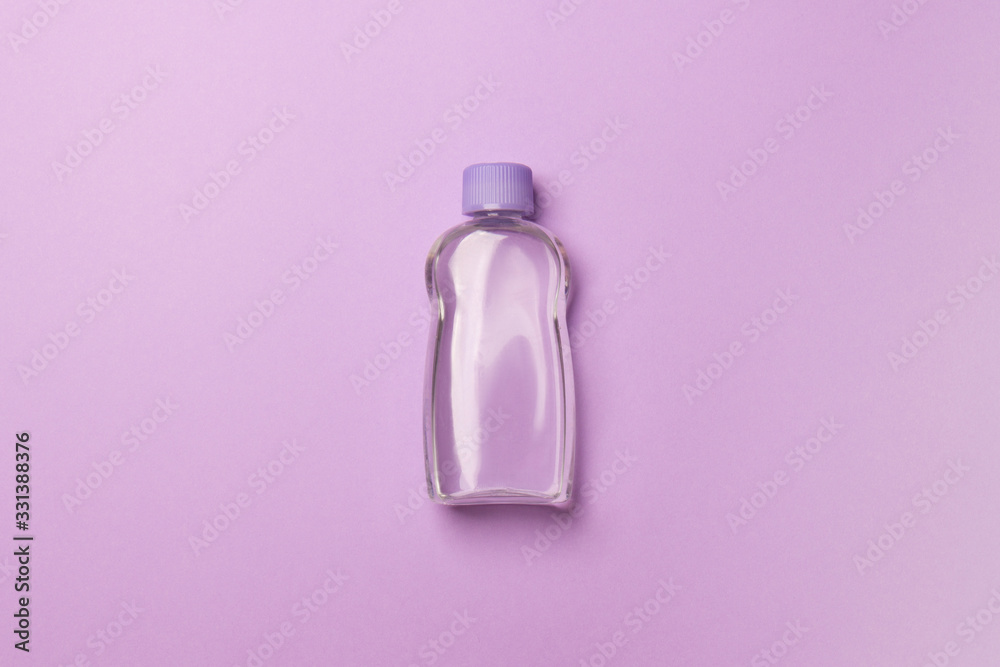 purple cosmetic bottle with liquid lying on purple background purple cosmetic bottle with liquid lying on purple background
