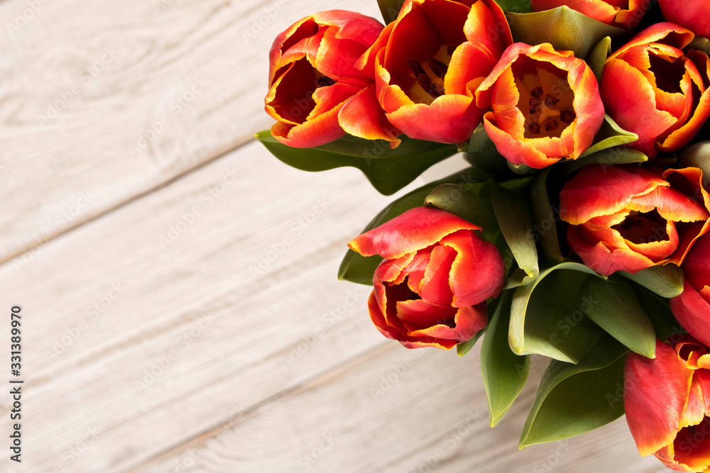 Bouquet of tulips on a light background. Concept image for a greeting card. Selective focus.