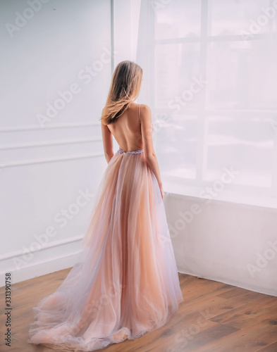 Fototapet Mysterious young woman princess in elegant beautiful airy luxury long evening trendy dress, bare open back