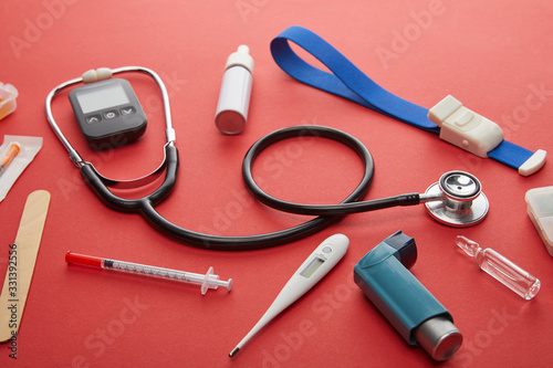 High Angle View of medical objects on red background