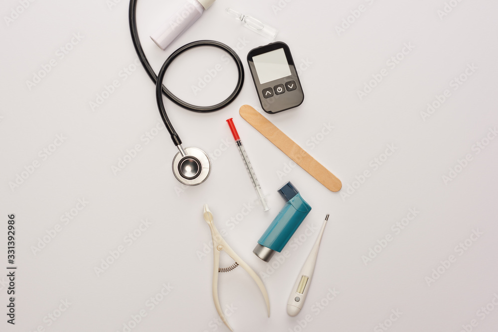 Top view of syringe, ampule and medical objects on white Top view of syringe, ampule and medical objects on white