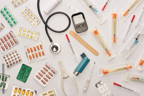Top view of pills, syringes and medical objects on white background
