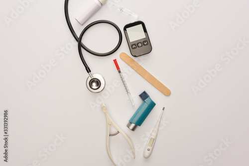 Top view of syringe, ampule and medical objects on white