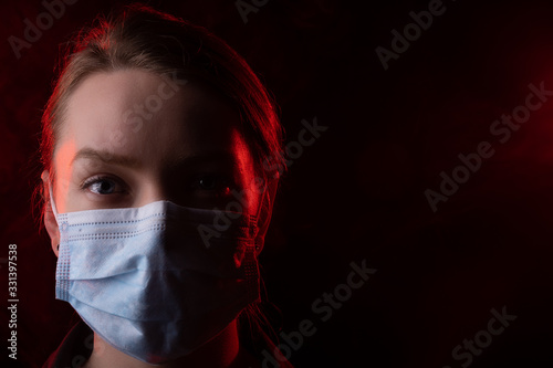 coronavirus, a girl in a mask on a black background. Title about the outbreak of the corona virus in China, illness. Epidemic