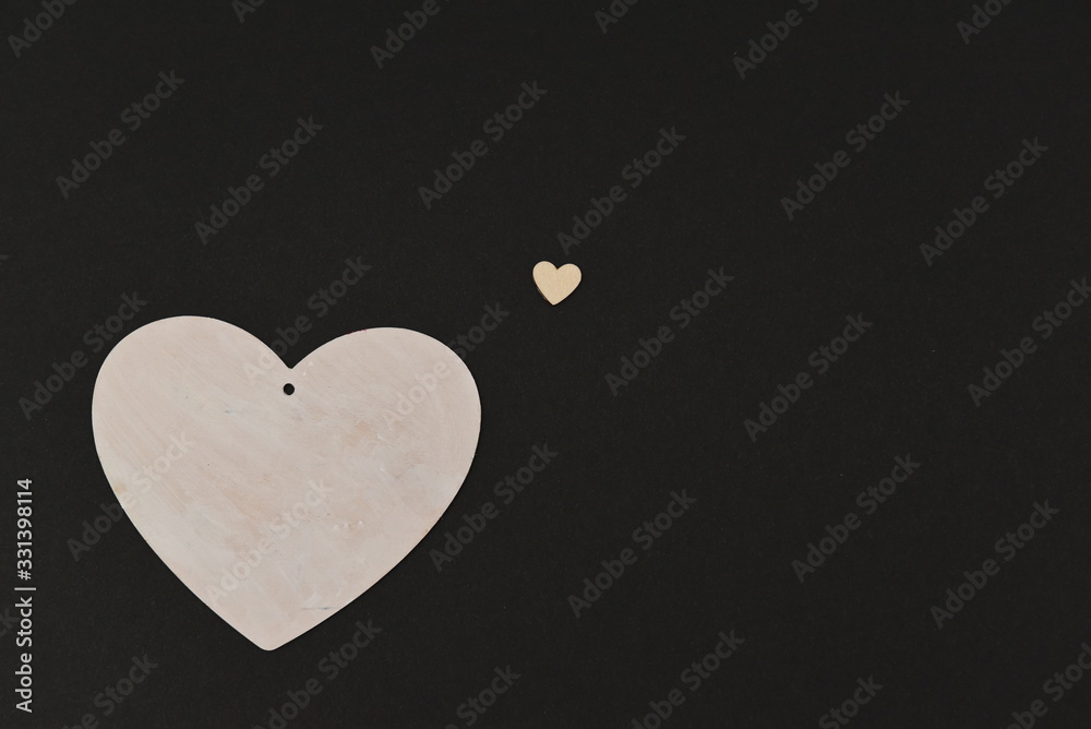 a large white heart made of wood and a small copy of it a large white heart made of wood and a small copy of it