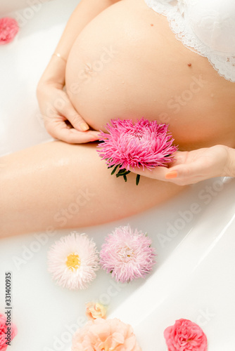 Beautiful pregnancy in a bath with flowers