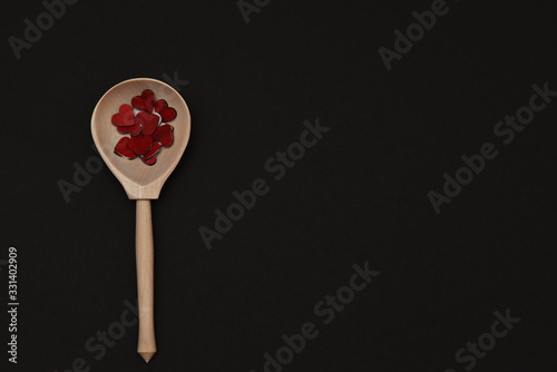 portion of love small red hearts in a spoon