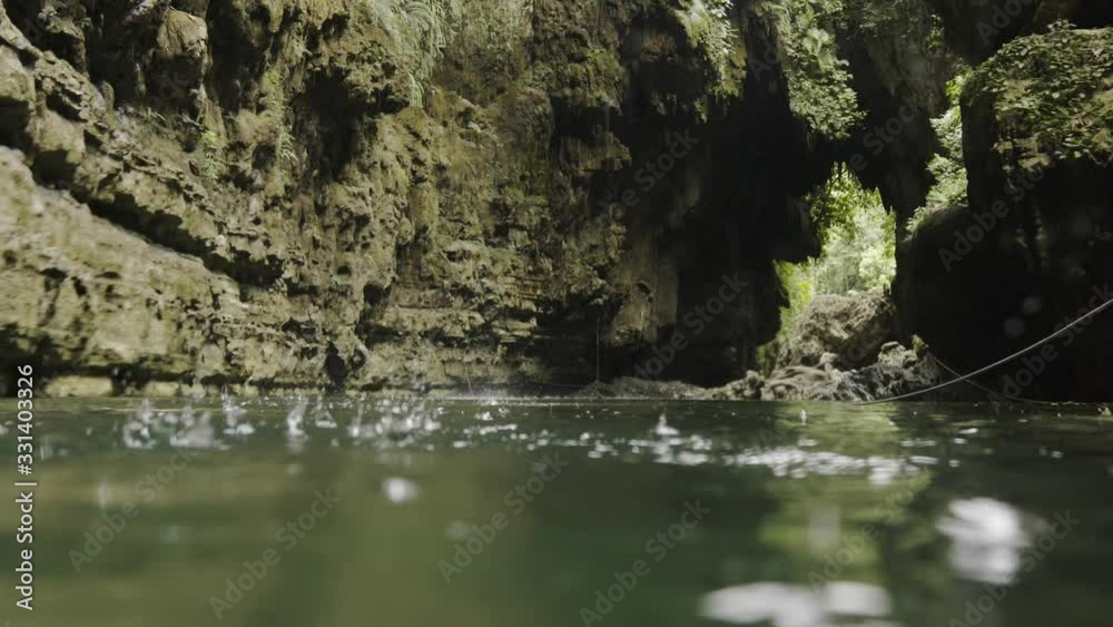 Green canyon underwater shot of canyon rocks river and water drops falling down in foreground, Java Indonesia Green canyon underwater shot of canyon rocks river and water drops falling down in foreground, Java Indonesia