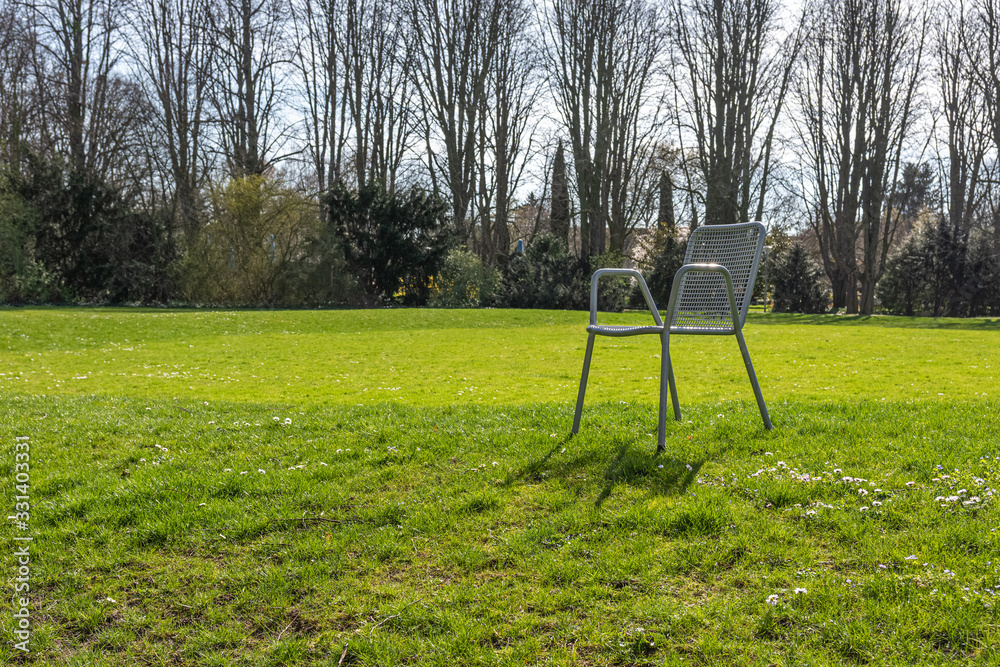 garden chair in a city park in spring garden chair in a city park in spring