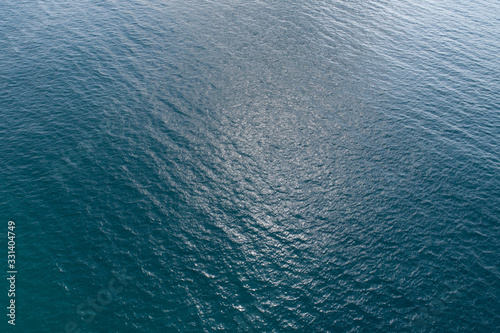 Drone aerial view of sea wave surface in the sunrise