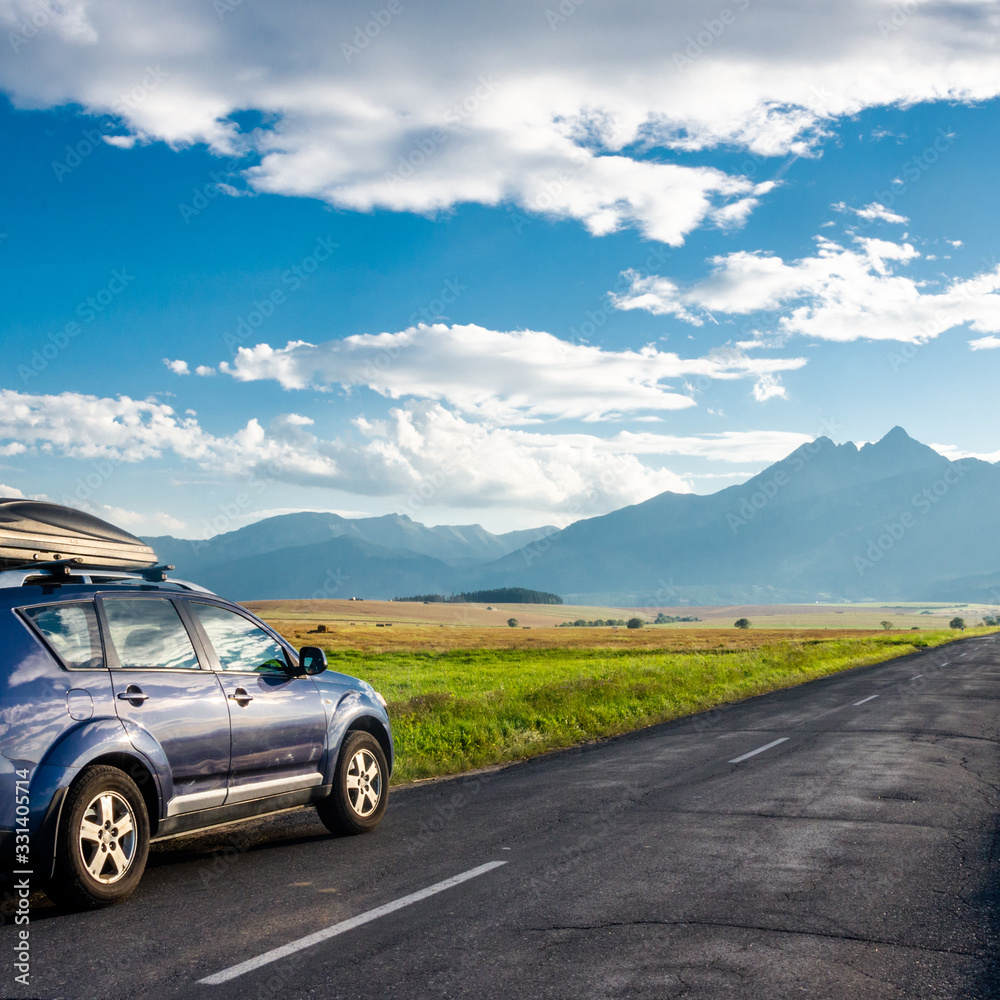 Naklejka premium car for traveling with a mountain road