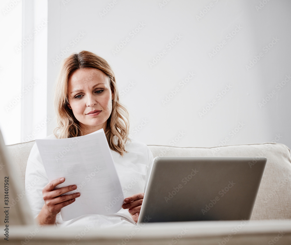 Mature woman at home checking her bills Mature woman at home checking her bills