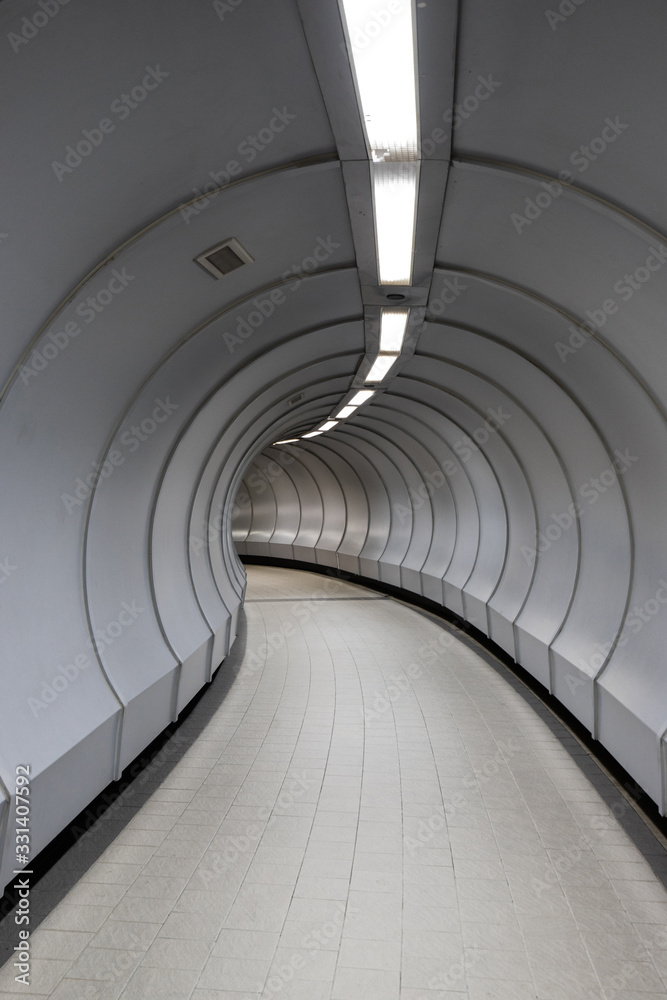 Fototapeta premium Curved walkway inside pedestrian crossing tunnel.