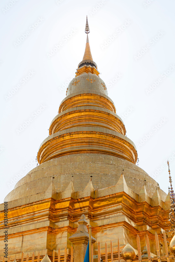 Fototapeta premium Beautiful Golden Pagoda in a Temple in Northern Thailand. Golden Pagoda background at the beautiful temple.