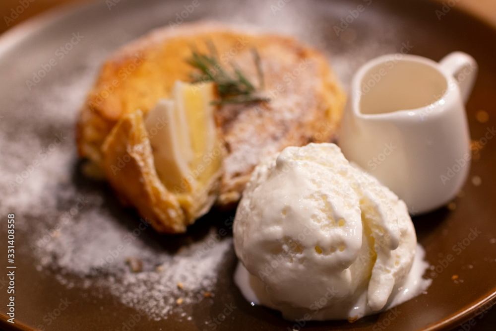 Ice Cream with coconut pie on a rustic plate with syrup. Homemade Vanilla Ice cream together with fresh make coconut pie. Selective focus of Ice Cream serve with Homemade coconut pie. Ice Cream with coconut pie on a rustic plate with syrup. Homemade Vanilla Ice cream together with fresh make coconut pie. Selective focus of Ice Cream serve with Homemade coconut pie.