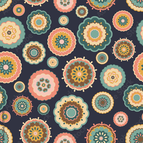 Seamless multicoloured pattern of retro flowers on a dark blue background. 